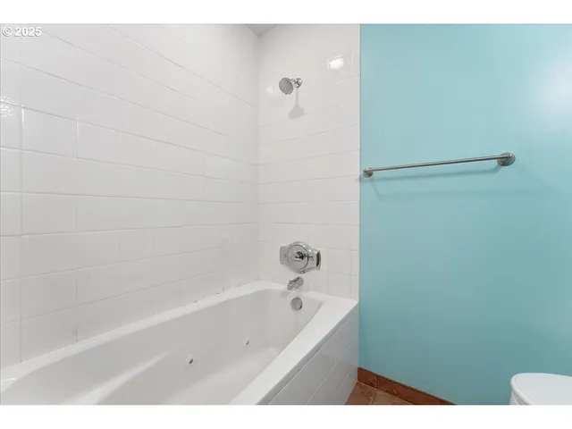 a bathroom with a bathtub and a shower