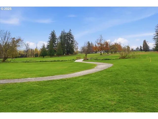 an aerial view of a houses with a yard