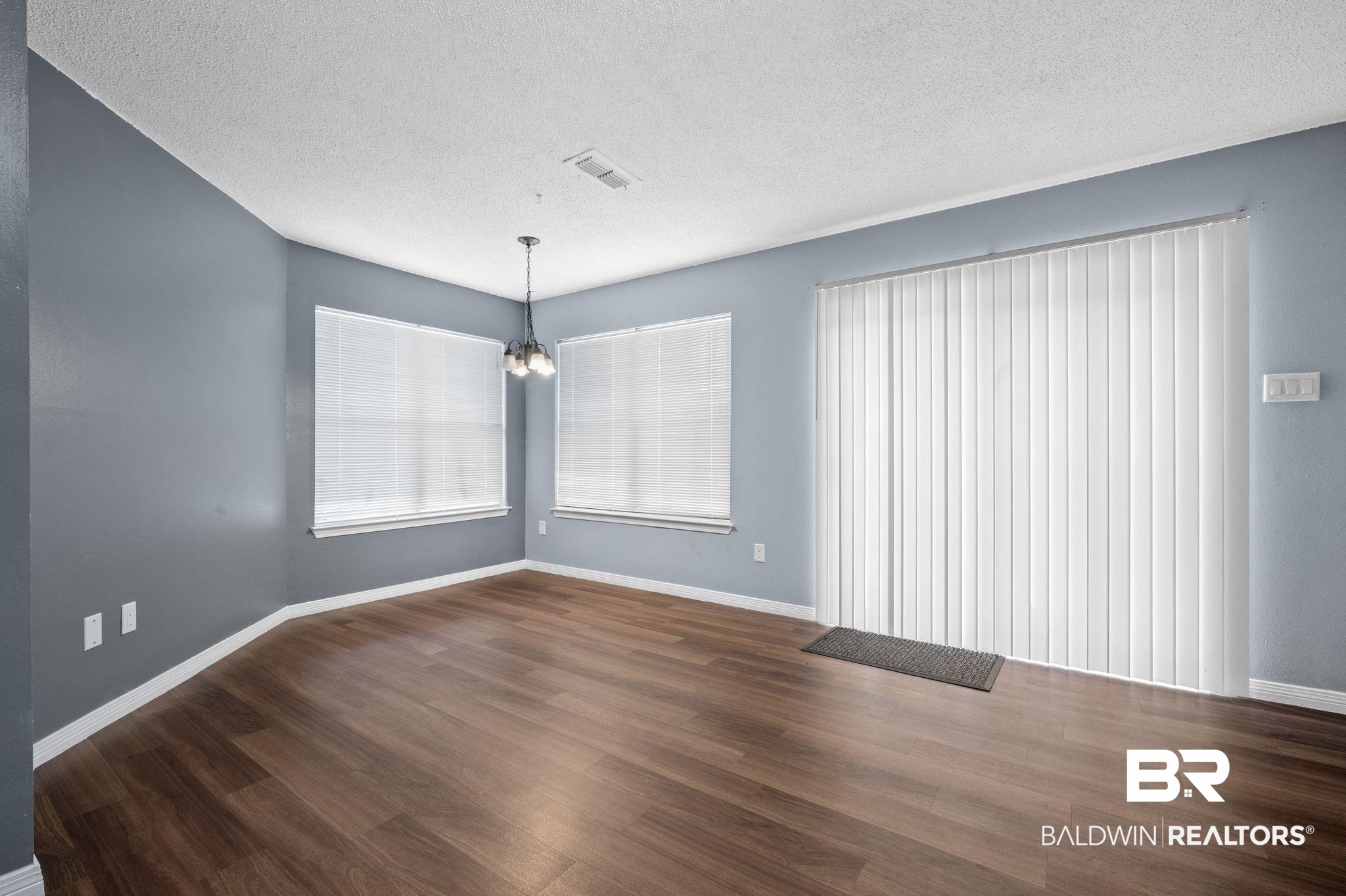 3716 Pepper Ridge Drive Mobile, AL 36693 - Photo 6 of 20 Spare room featuring a textured ceiling, a chandelier, and dark hardwood / wood-style floors