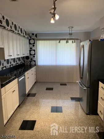 a kitchen with a refrigerator and a sink