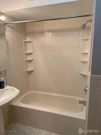 a bathroom with a shower and a bath tub