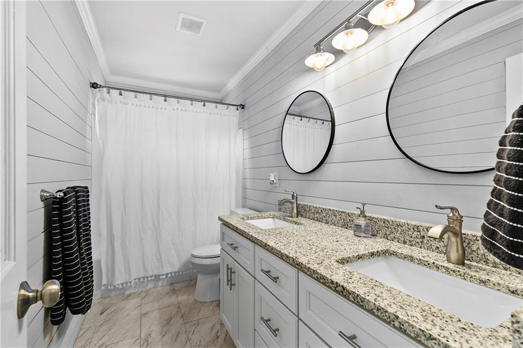 208 Shadowlawn Road Southeast Marietta, GA 30067 - Photo 11 of 25 a bathroom with a granite countertop double vanity and a mirror