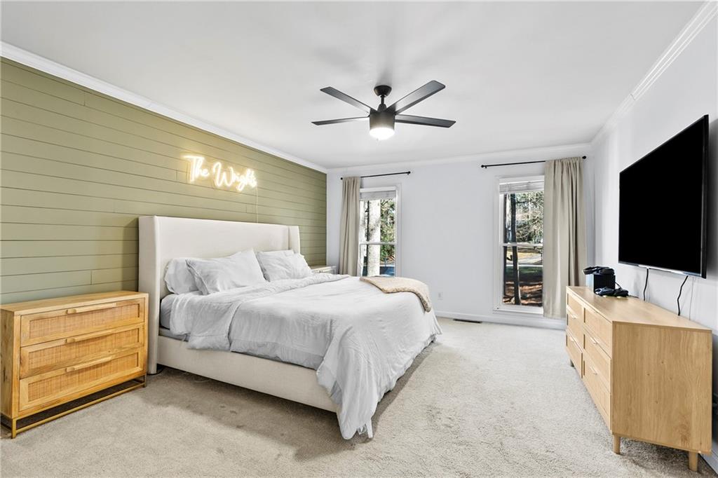 208 Shadowlawn Road Southeast Marietta, GA 30067 - Photo 12 of 25 a bedroom with a bed and a flat screen tv