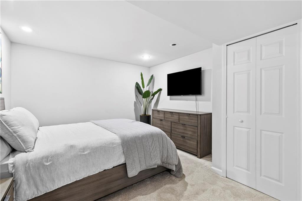 208 Shadowlawn Road Southeast Marietta, GA 30067 - Photo 19 of 25 a bedroom with a bed and a flat screen tv