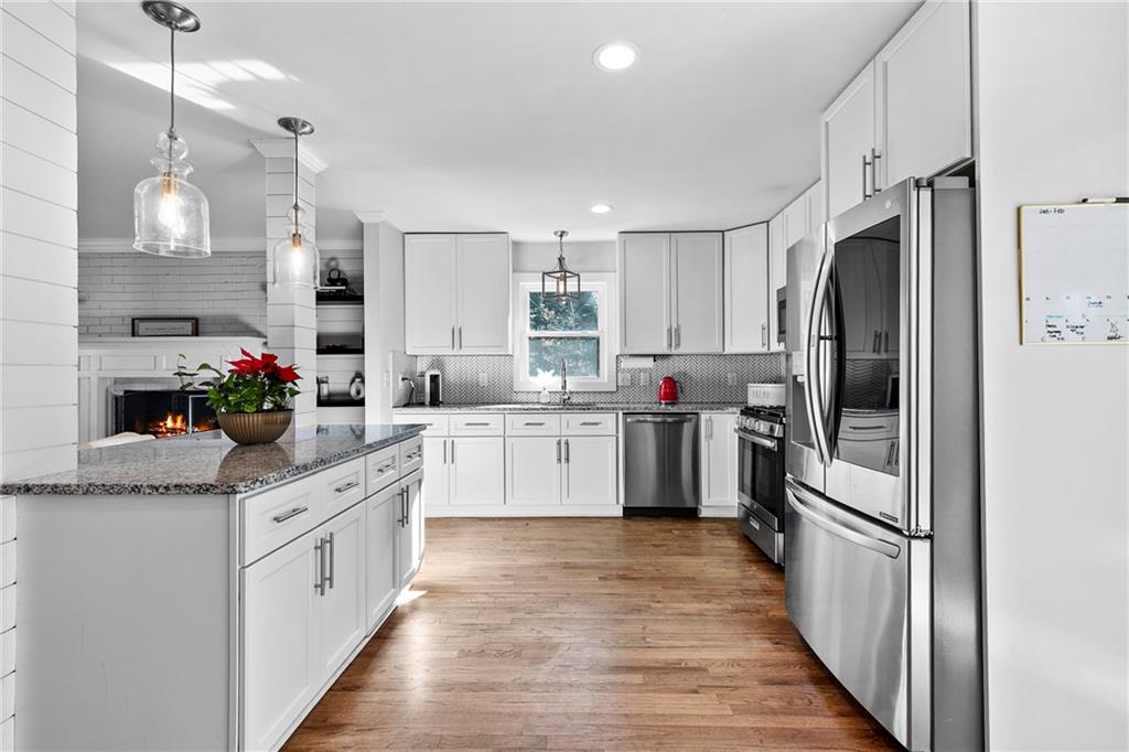 208 Shadowlawn Road Southeast Marietta, GA 30067 - Photo 7 of 25 a kitchen with white cabinets and stainless steel appliances