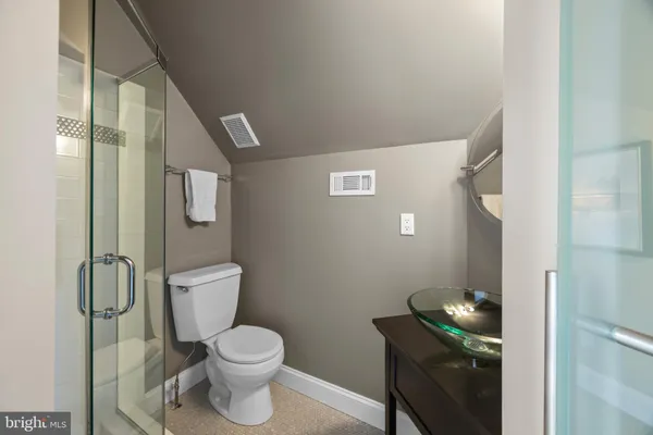 a bedroom with a bed and a lamp