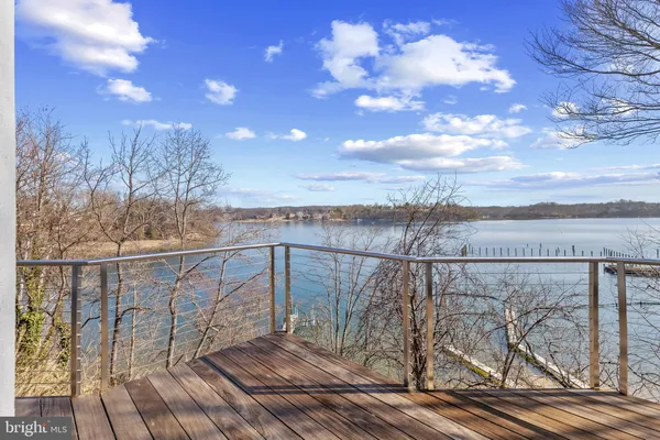 a view of a balcony with wooden floor and city view