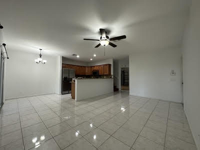 a view of a kitchen with a sink and chandelier fan