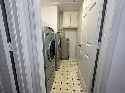 140 Baldwin Boulevard Greenacres, FL 33463 - Photo 11 of 12 a utility room with sink dryer and washer