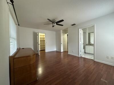 140 Baldwin Boulevard Greenacres, FL 33463 - Photo 6 of 12 wooden floor in an empty room with a window