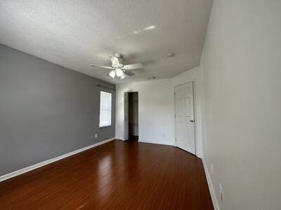 140 Baldwin Boulevard Greenacres, FL 33463 - Photo 9 of 12 a view of an empty room with wooden floor