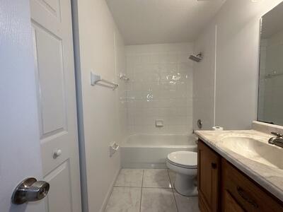 140 Baldwin Boulevard Greenacres, FL 33463 - Photo 10 of 12 a bathroom with a granite countertop sink a toilet and shower
