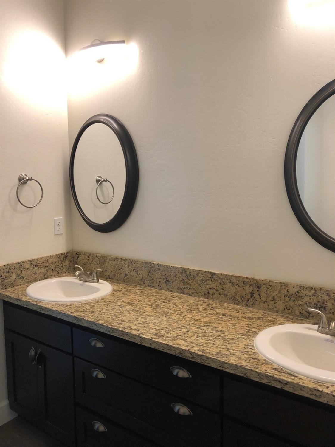 159 North Belmont Road Exeter, CA 93221 - Photo 20 of 28 a bathroom with a granite countertop sink and a mirror