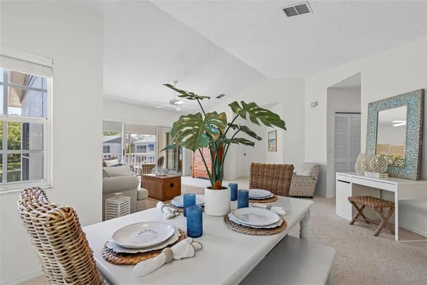 a view of a house with pool and sitting area