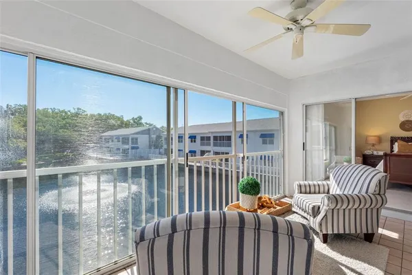 a living room with furniture and a floor to ceiling window