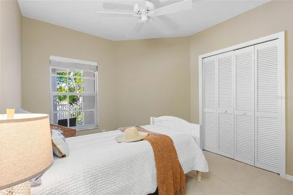 an aerial view of a tennis ground and a cars park side of the road