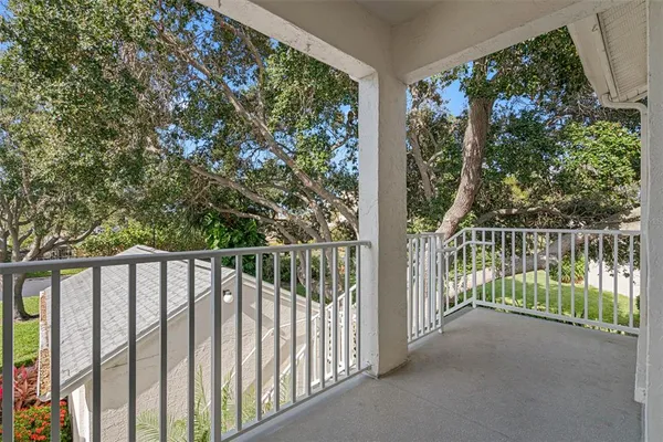 a kitchen with stainless steel appliances granite countertop a refrigerator a stove and a sink with wooden floor