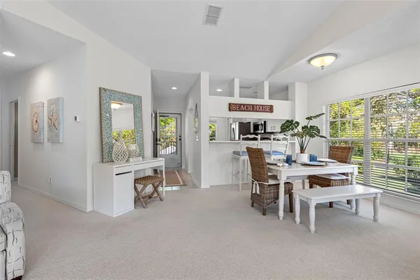 a kitchen with stainless steel appliances a refrigerator sink and white cabinets