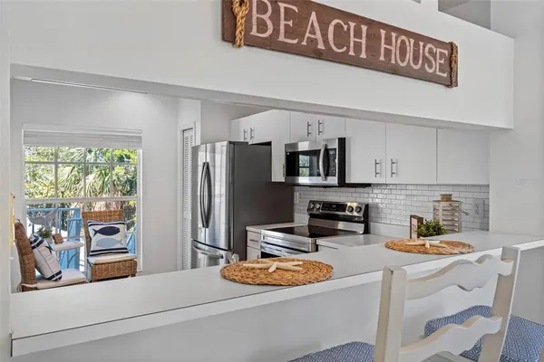 a kitchen with a sink stove top oven and cabinets