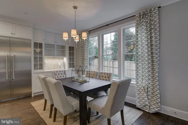 a dining room with furniture window and wooden floor
