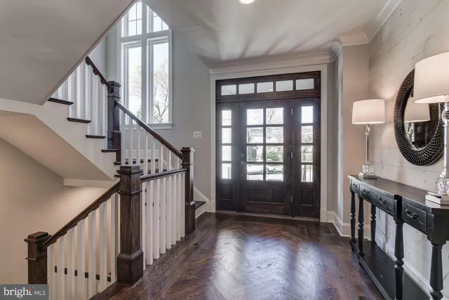 a view of entryway with wooden floor and windows