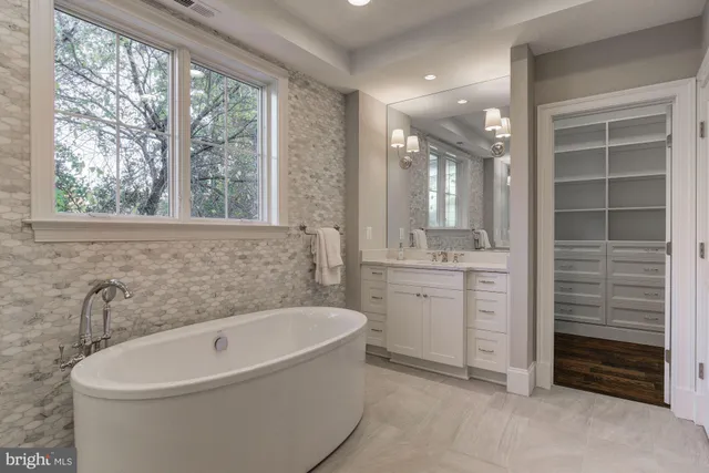 a bathroom with a bathtub sink and window