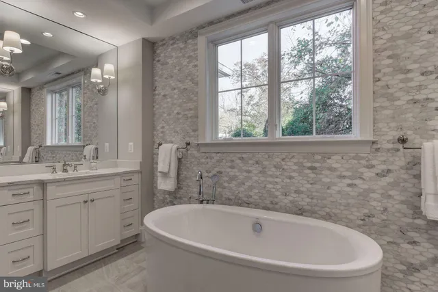 a white bath tub sitting next to a white sink