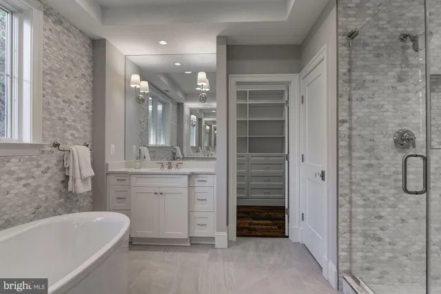 a bathroom with a granite countertop sink a toilet and shower