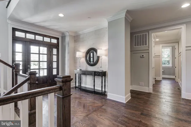 a view of a hallway with wooden floor and entryway