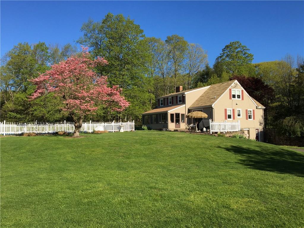 a large house with a big yard and large trees