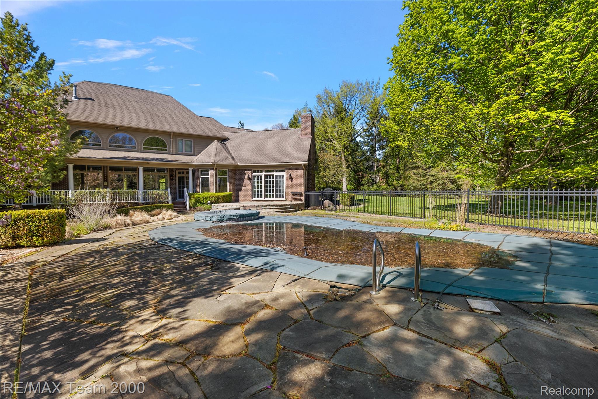 630 Sheldon Court Rochester, MI 48306 - Photo 90 of 94 View of swimming pool with a hot tub and patio surround