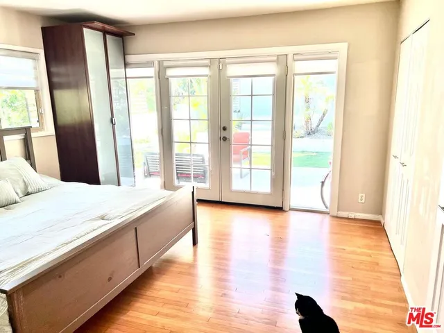 a spacious bedroom with a large bed and a large window