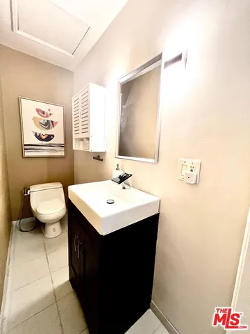 a bathroom with a sink a toilet and mirror