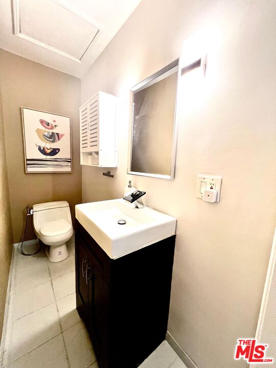 4340 Sepulveda Boulevard Sherman Oaks, CA 91403 - Photo 14 of 30 a bathroom with a sink a toilet and mirror