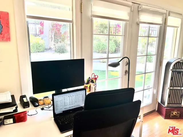 a living room with large window and a flat screen tv