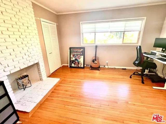 a room with wooden floor and furniture