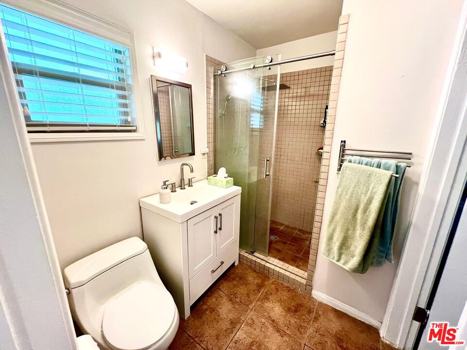 4340 Sepulveda Boulevard Sherman Oaks, CA 91403 - Photo 18 of 30 a bathroom with a sink a toilet and a mirror