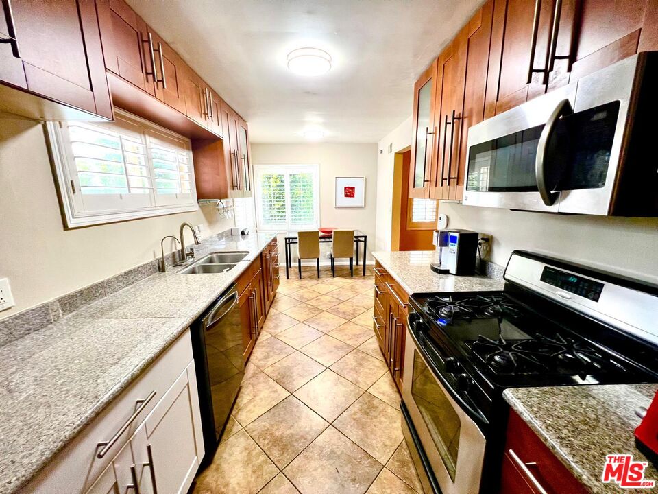 4340 Sepulveda Boulevard Sherman Oaks, CA 91403 - Photo 23 of 30 a large kitchen with stainless steel appliances granite countertop a stove and a sink