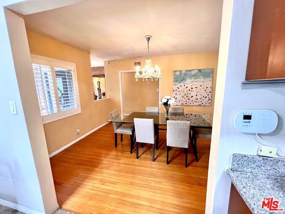 4340 Sepulveda Boulevard Sherman Oaks, CA 91403 - Photo 6 of 30 a dining room with furniture a chandelier and wooden floor