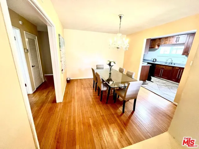 a dining room with furniture and wooden floor