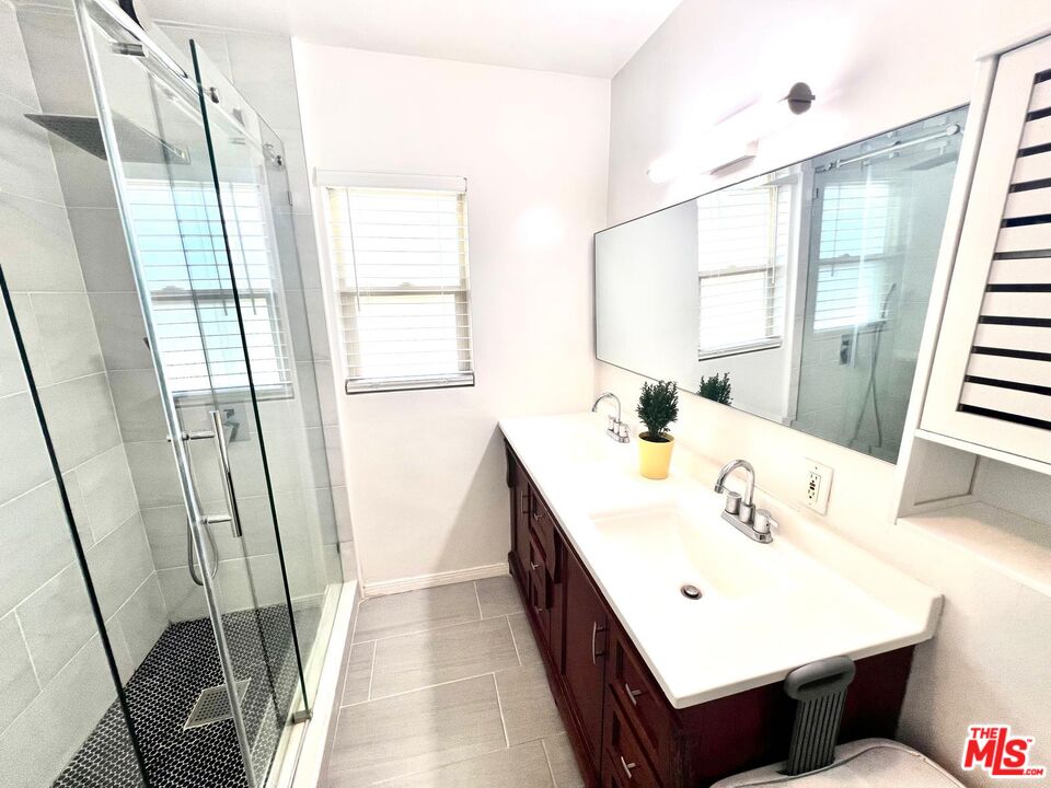 4340 Sepulveda Boulevard Sherman Oaks, CA 91403 - Photo 10 of 30 a bathroom with a sink a mirror and a shower