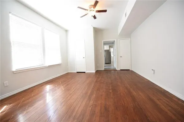 wooden floor in an empty room with a window