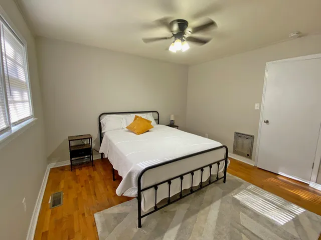 a bedroom with a bed and a chandelier