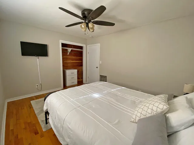 a bedroom with a bed and a flat screen tv
