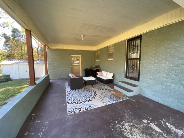 a living room with furniture rug and a table