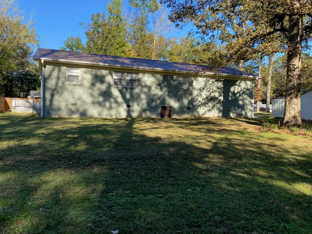 a view of a yard with large trees