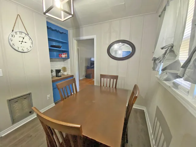 a view of a dining room with furniture and a large window