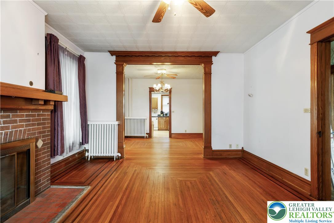 4349 Main Street Whitehall, PA 18052 - Photo 16 of 42 a view of a hallway with wooden floor and a fireplace