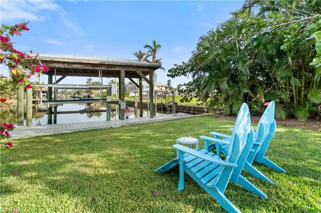 a view of a chairs and table in backyard of the house