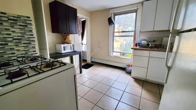 a kitchen with a stove a sink and a refrigerator